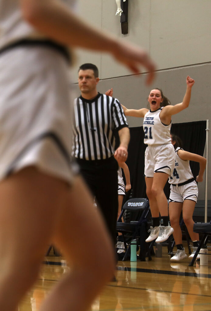 Tolton post Ellie Reynolds cheers after her team scores a basket